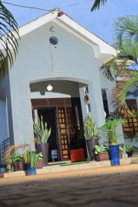 a house with plants in front of it at Cozy Retreat in Kampala