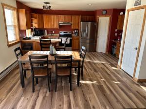 a kitchen with a wooden table and chairs at YellowstoneMigrant in Emigrant