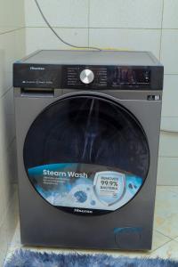 aether washer and dryer sitting on a floor at Cozy Retreat in Kampala