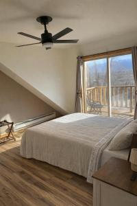 a bedroom with a bed and a large window at YellowstoneMigrant in Emigrant