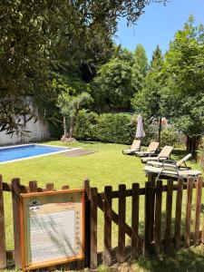 a fence with a sign next to a swimming pool at Bungalow Gerês - Pichoses Camping in Rio Caldo +4 photos