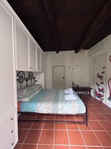 a bedroom with a bed and a table in it at Il Sasso appartamento in Orta San Giulio