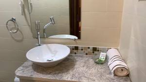 a bathroom with a sink and a mirror at Ibitur Hotel in Ibiúna