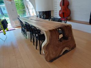 a table made out of a tree stump in a room at Villa Roma in Montluçon +19 photos