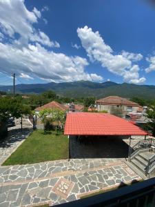 a view of a red roof with mountains in the background at Papadopoulos House in Kavála
