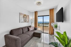 a living room with a couch and a tv at Atlantic Sky Panorama in Costa Del Silencio