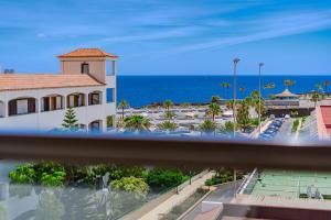 a view of a building with the ocean in the background at Atlantic Sky Panorama in Costa Del Silencio