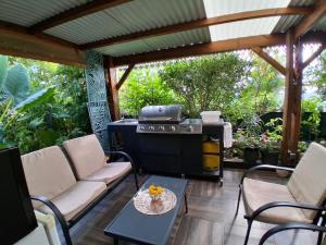 a patio with a grill and a table and chairs at La Varangue in La Possession