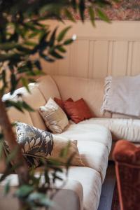 a couch with pillows on it in a living room at Valldal Fjord Lodge B&B in Valldal