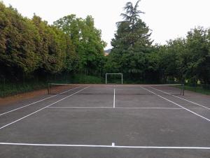 a tennis court with a net on it at Casa De Fatauncos in Vouzela