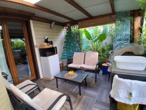 a patio with chairs and a table and a sink at La Varangue in La Possession