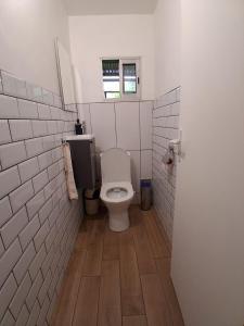a small bathroom with a toilet and a window at La Varangue in La Possession +5 photos
