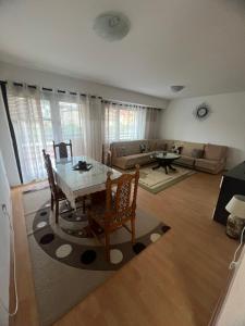 a living room with a table and chairs and a couch at MarBel Apartments in Ohrid