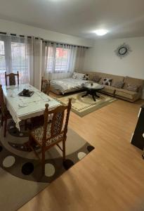 a living room with a table and a couch at MarBel Apartments in Ohrid