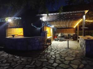 a patio lit up at night with lights at RELAIS du BECASSIER in Annot