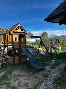 a playground with a slide and a play house at Ziaciówka Noclegi Premium w Górach in Rzepiska