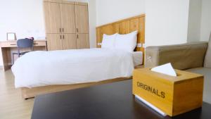 a hotel room with a bed and a yellow box at Didi House無人化自助入住 in Tainan +36 photos