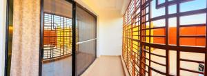 a room with a hallway with a window and a door at Prestige A4 in Ouagadougou