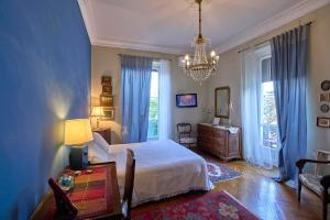 a bedroom with a bed and a table and a chandelier at A Casa Armenia B&B in Turin