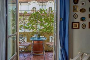 a room with a table and chairs on a balcony at A Casa Armenia B&B in Turin
