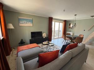 a living room with a couch and a table at Relax & Sea in Ostend