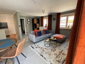 a living room with a couch and a table at Relax & Sea in Ostend
