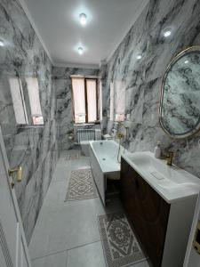 a bathroom with a tub and a sink and a mirror at 14 берёз in Borovoye