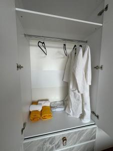 a closet with white towels and yellow towels at 14 берёз in Borovoye