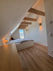 a bedroom with a bed and a window at Timmendorfer Herz in Timmendorfer Strand