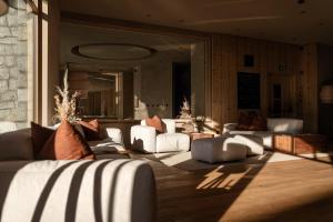 a living room with white couches and a large mirror at Hotel Masl in Valles