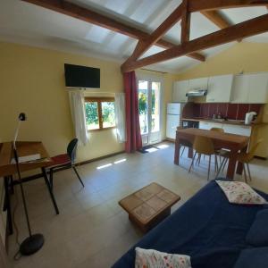 a living room with a blue couch and a table at Domaine La Salamandre - Piscine & Forêt privée, Vue sur Vallée in Lauzerte