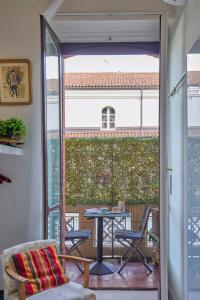 a patio with a table and chairs on a balcony at A Casa Armenia B&B in Turin