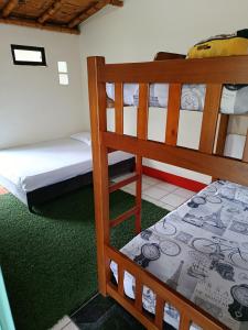 two bunk beds in a room with green carpet at la embajada hospedaje in San Rafael