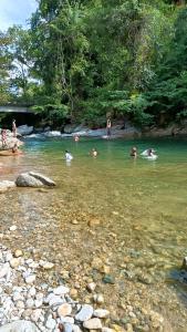 a group of people swimming in a river at la embajada hospedaje in San Rafael