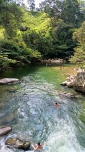 a group of people swimming in a river at la embajada hospedaje in San Rafael