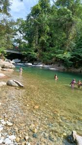 a group of people swimming in a river at la embajada hospedaje in San Rafael +2 photos