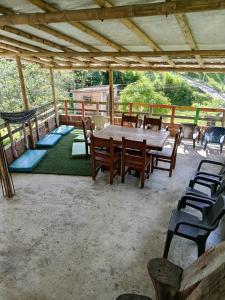a patio with a wooden table and chairs on it at la embajada hospedaje in San Rafael