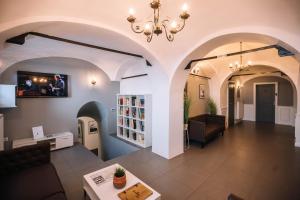 a living room with a couch and a chandelier at 4 Rooms in Maribor