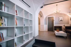 a living room with bookshelves and a couch at 4 Rooms in Maribor +16 photos