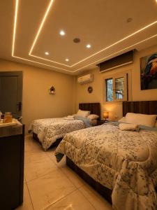 a hotel room with two beds in a room at Pyramids Green View in Cairo