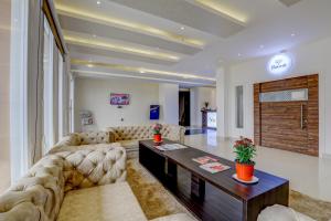a living room with a couch and a table at Banari Regency by Summit in Namchi