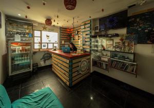 a woman sitting at a counter in a store with a laptop at Mandala Yoga Hostel in Bogotá