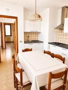 a kitchen with a table and chairs in a room at Charming House Among the Prosecco Hills & Olive Groves in San Pietro di Feletto