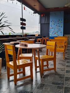 a group of tables and chairs in a restaurant at Home in Hố Nai