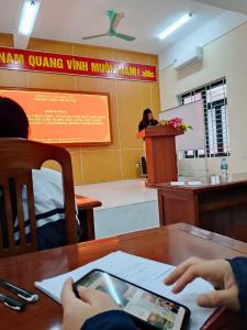 a person sitting at a table with a tablet at Home in Hố Nai
