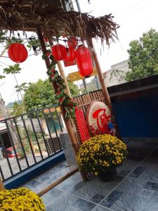 a swing with red lanterns and flowers on a balcony at Home in Hố Nai
