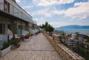 a balcony of a building with a view of the water at Vila Dena in Vlorë