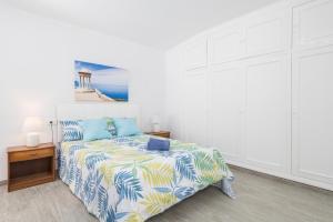 a bedroom with a bed and a painting on the wall at Can M Tatau in Santanyi +22 photos
