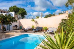 a villa with a swimming pool and a patio at Can M Tatau in Santanyi