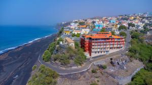 an aerial view of a building on a hill next to the ocean at Hotel Ocean View & Restaurante Seafood in São Filipe